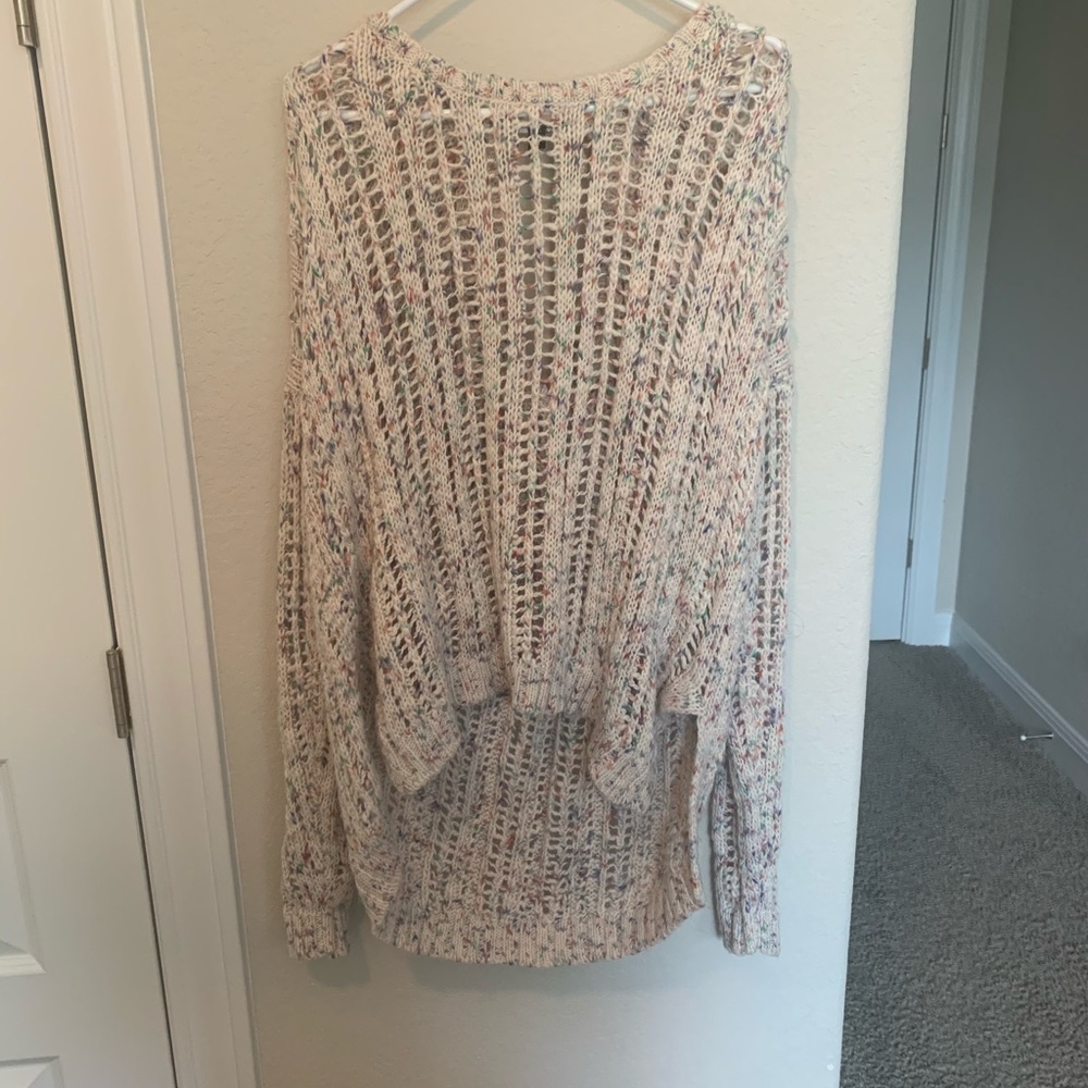 Open knit pastel sweater with tie in back